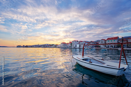 Fototapeta Naklejka Na Ścianę i Meble -  Beautiful sunset landscape. Fishing boat moored on Kastel coast in Dalmatia,Croatia.Old town near Adriatic sea.