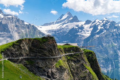 Grindelwald, Switzerland - View of Grindelwald First Cliff Walk, with many tourists walking the observation platform photo