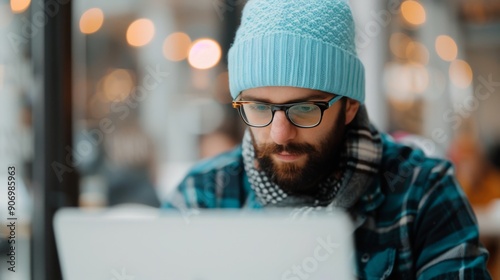 Professional Man Working Intently at Laptop in Modern Office Environment