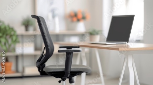 Modern Office Chair at Home Workspace With Laptop on Wooden Desk