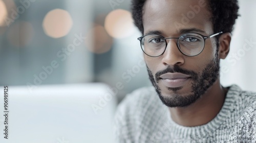 Smiling Man Working on Laptop in Modern Office During Daytime