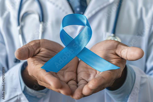 Doctor hands holding blue ribbon, cancer awareness concept