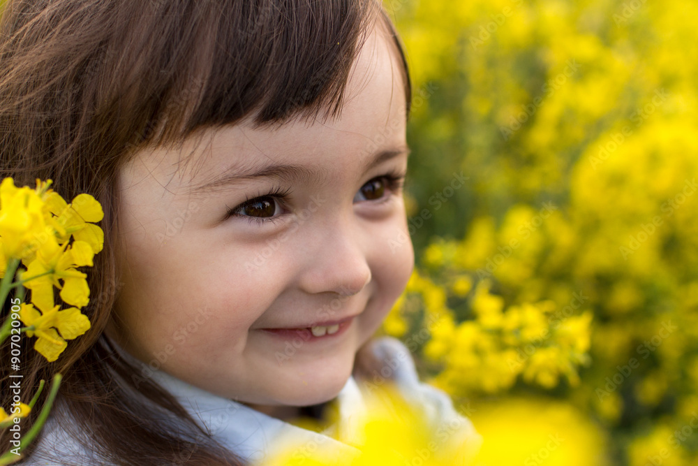 a little girl in a field of flowering yellow. field. girl with yellow flowers a little girl in a field of flowering yellow. field. girl with yellow flowers