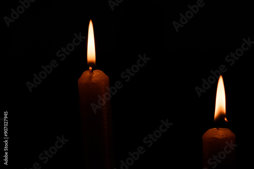 burning candle on black