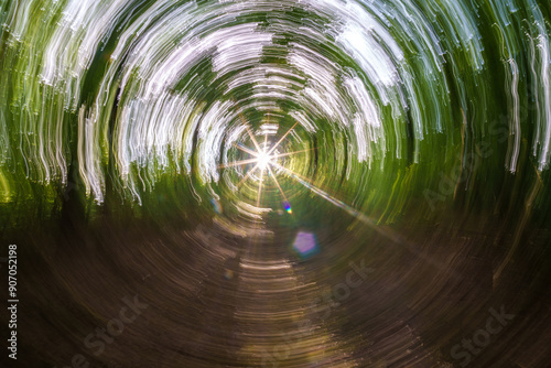 Experience the mesmerizing light shining through a vivid and enchanting green tunnel, sunstar photo