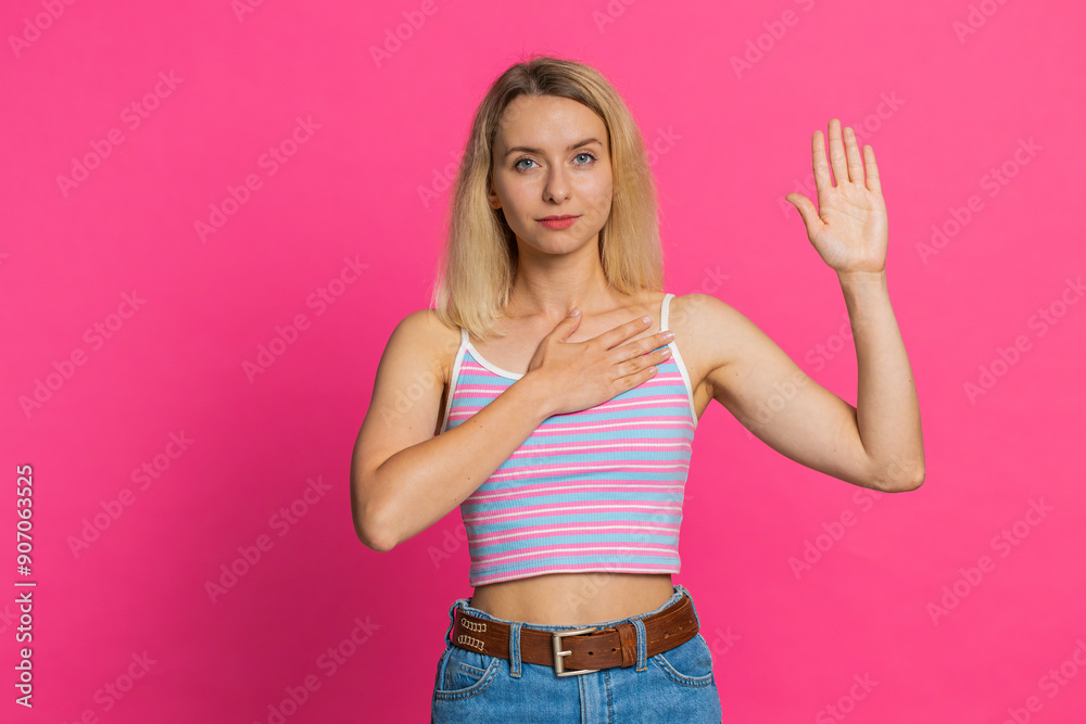 I swear to be honest. Sincere responsible Caucasian young woman 30 years old raising hand to take oath, promising to be honest, to tell truth, keeping hand on chest, justice. Girl on pink background I swear to be honest. Sincere responsible Caucasian young woman 30 years old raising hand to take oath, promising to be honest, to tell truth, keeping hand on chest, justice. Girl on pink background