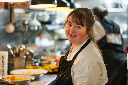 Portrait of a Girl with Down Syndrome working in the Restaurant Kitchen, Close up Young Disabled Girl with Freckles, Fringe, Happy with Disability photo