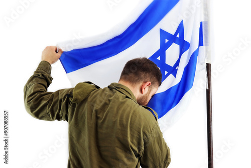 Israeli soldier kisses the flag of Israel on the white background photo