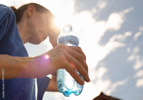 Woman drinking water in extreme heat photo