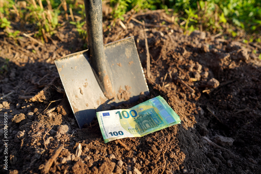 Shovel with Euro money on ground. Bury money. Digging money in soil. Digs EURO coins note from ground. EURO bills in European Union Crisis. Euro bills growing out of soil. Burying money in backyard. Shovel with Euro money on ground. Bury money. Digging money in soil. Digs EURO coins note from ground. EURO bills in European Union Crisis. Euro bills growing out of soil. Burying money in backyard.