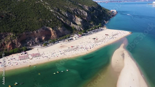 Figueirinha White Beach and Sandspit, Green Mountain and Atlantic Ocean. Portugal. Aerial Drone Shot. Moving Backwards photo