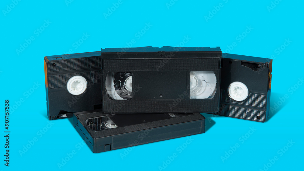 old black plastic VHS video cassette with on a blue surface against blue background old black plastic VHS video cassette with on a blue surface against blue background