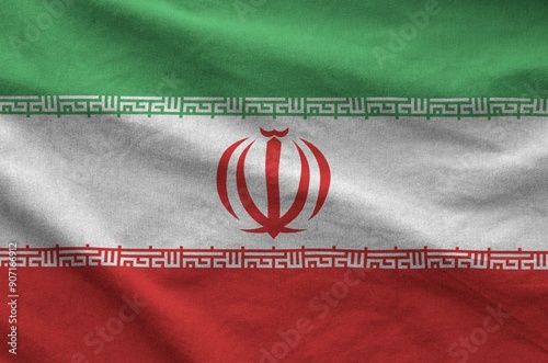 Iran flag depicted on folded wavy fabric of old cloth close up photo