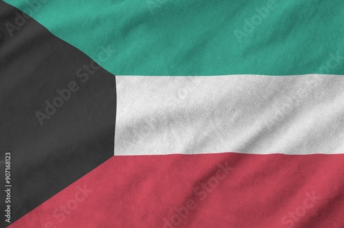 Kuwait flag depicted on folded wavy fabric of old cloth close up photo