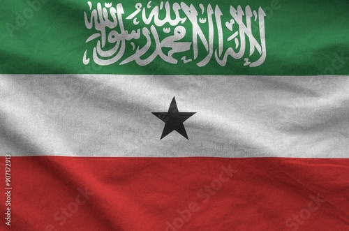 Somaliland flag depicted on folded wavy fabric of old cloth close up photo