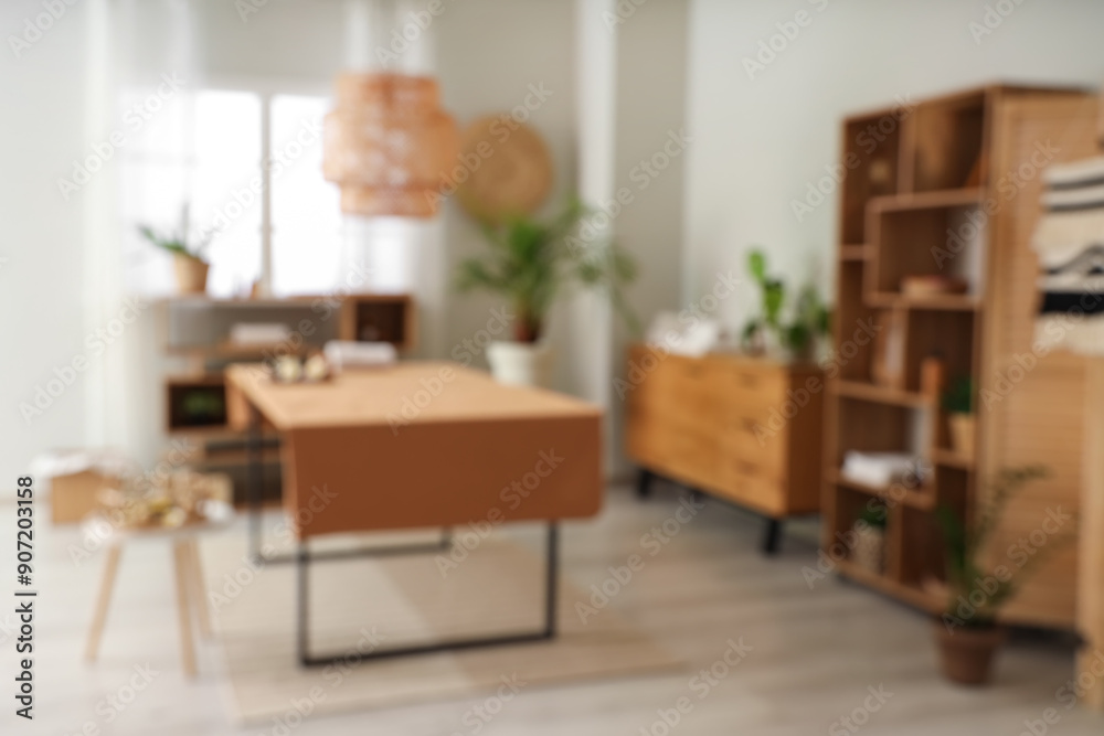 Blurred view of spa salon with massage table and shelf units Blurred view of spa salon with massage table and shelf units