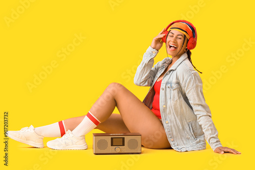 Joyful young woman listenin...