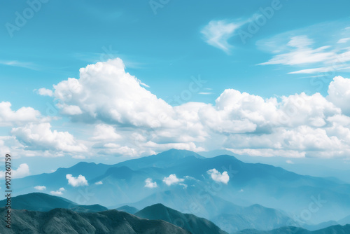 A serene landscape featuring distant mountains under a clear blue sky adorned with fluffy clouds, perfect for nature enthusiasts.