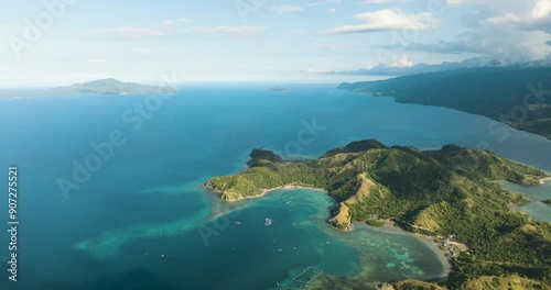 Topical landscape of sleeping dinosaur island with azure water and corals in coastal. Mati, Davao Oriental. Philippines. photo