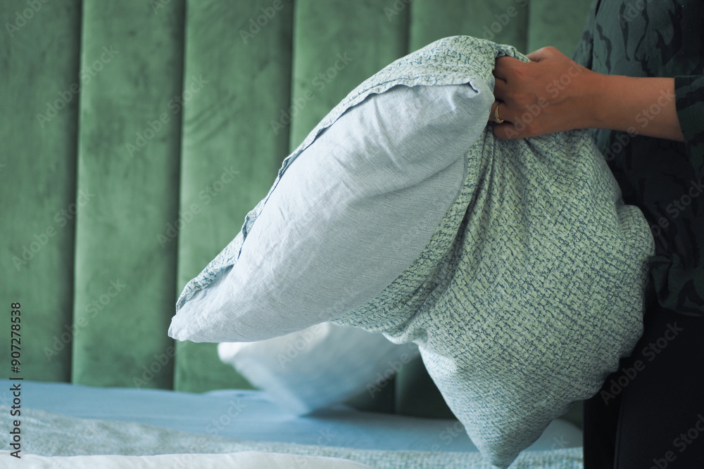 Poster Print Woman Puts Pillow Into Pillowcase. 40x26.7 cm
