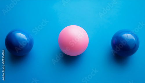 outstanding pink sphere among blue sphere on blue background. minimalist