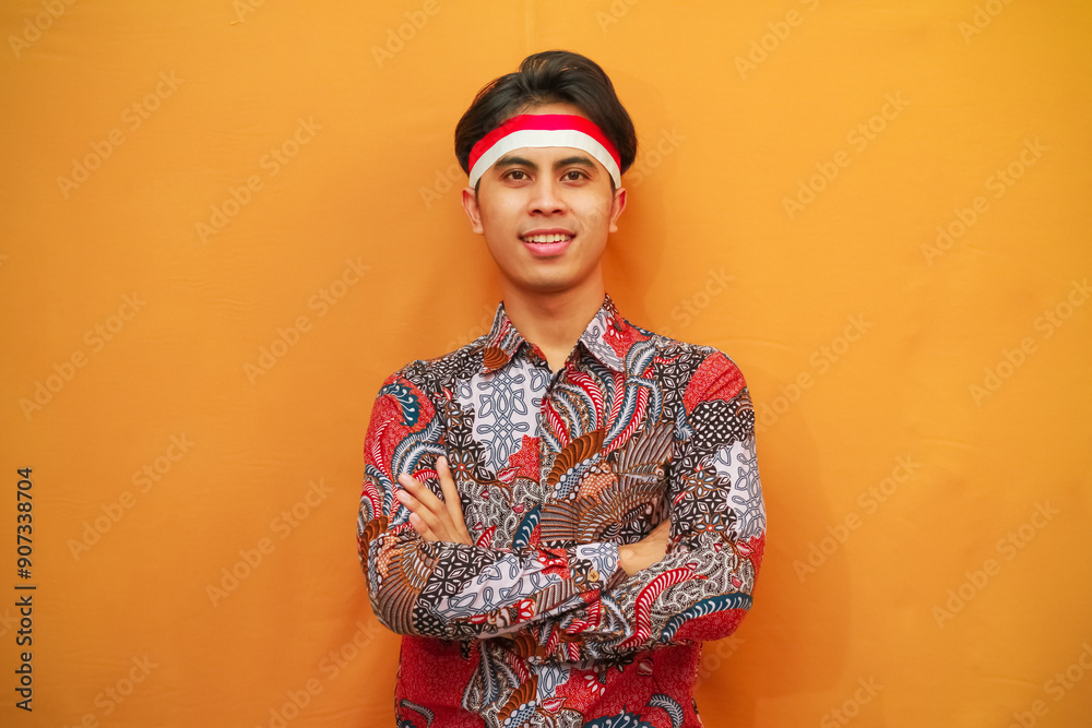 Handsome Indonesian man in Batik shirt celebrating Indonesian Independence Day on August 17 concept, posing with confident dashing and looking at the camera Handsome Indonesian man in Batik shirt celebrating Indonesian Independence Day on August 17 concept, posing with confident dashing and looking at the camera