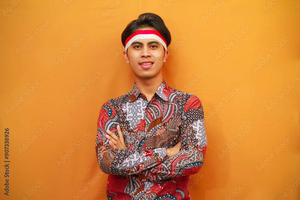 Handsome Indonesian man in Batik shirt celebrating Indonesian Independence Day on August 17 concept, posing with confident dashing and looking at the camera Handsome Indonesian man in Batik shirt celebrating Indonesian Independence Day on August 17 concept, posing with confident dashing and looking at the camera