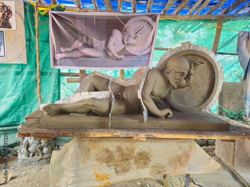 Indian Art, Closeup of sculptor or artist working on clay sculpture, making Gypsum mold of an Dying warrior (fallen Trojan warrior, Laomedon) clay Sculpture, craft or handmade.
 photo