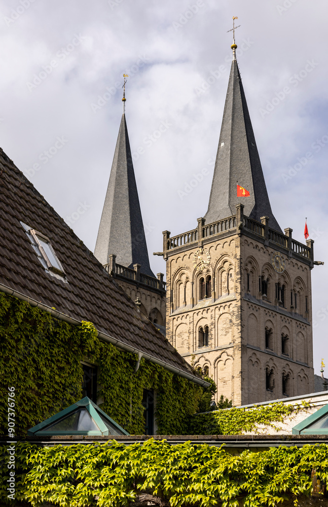 Fototapeta premium tall sharp spire of a tower building in a small town in europe 