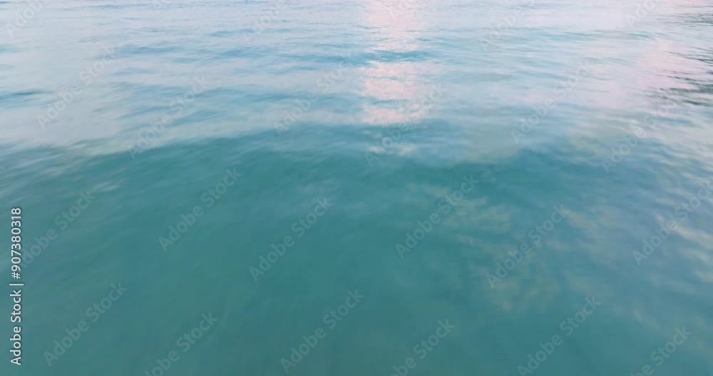 Aerial drone view of clear turquoise sea and waves over the ocean.