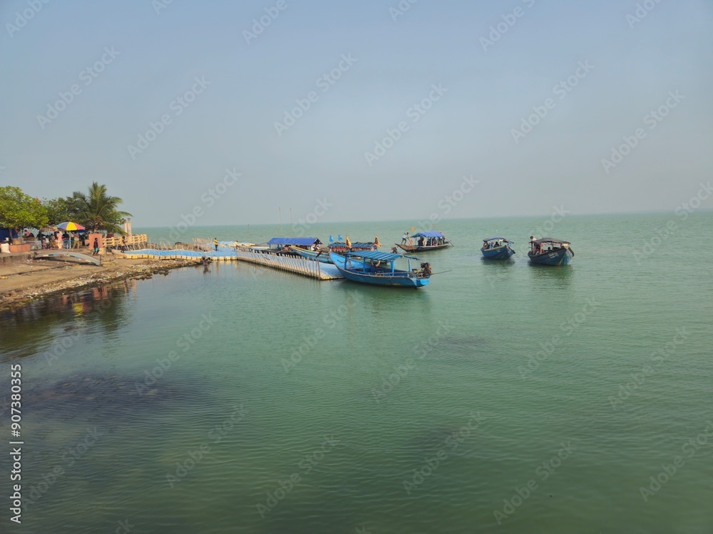 Boats in the the Chilika lake. Chilika lake is the largest coastal lagoon in Odisha India and the largest brackish water lagoon in the world. Boats in the the Chilika lake. Chilika lake is the largest coastal lagoon in Odisha India and the largest brackish water lagoon in the world.