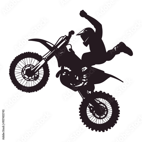 Silhouette of a motocross rider performing a stunt. 