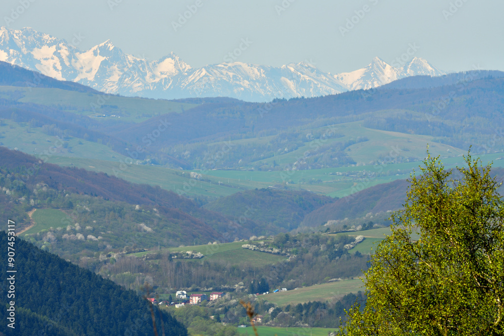 Fototapeta premium Surrounding valleys and mountains and view from of the high peaks of snow-capped mountains 