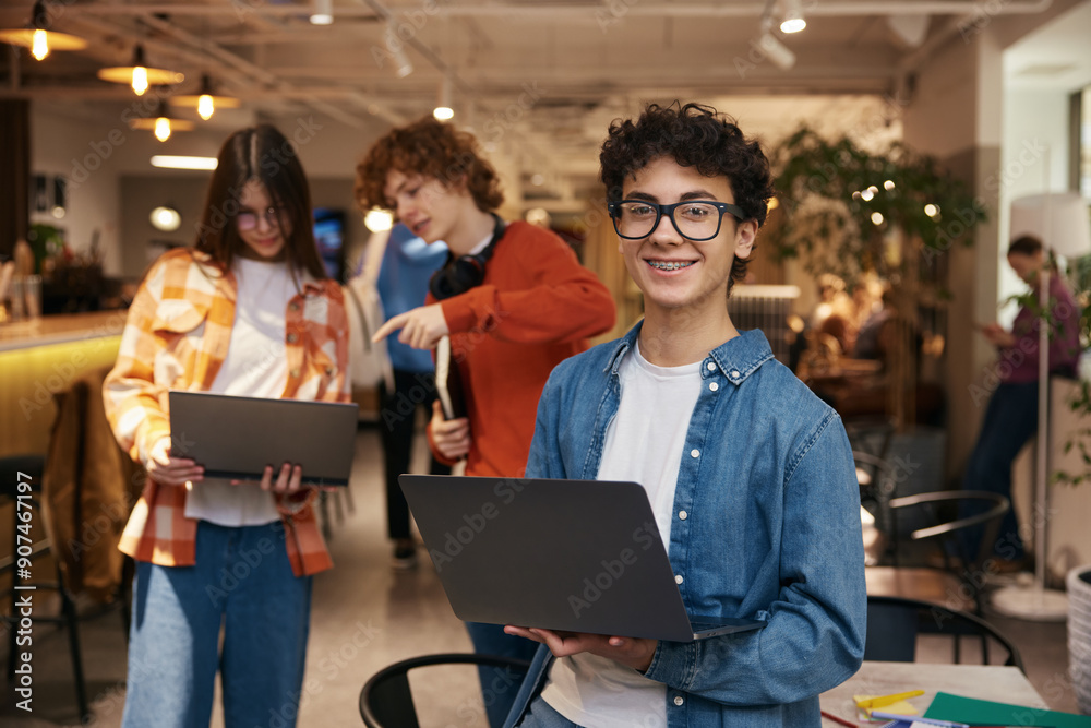 Group of teenagers working in office together
