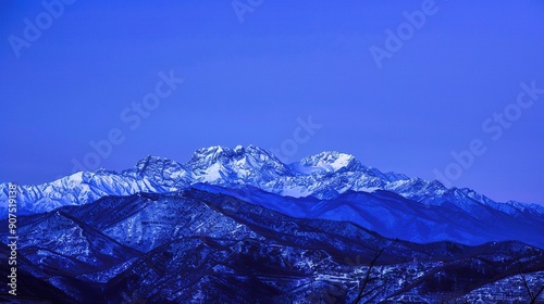 The Magnificent Snow-Capped Mountains Against the Blue Sky Background at Night in Rizhao Jinshan. A Stunning Natural Sight that Evokes Peace and Awe. The Beauty of Nature in Its Pristine Form. photo