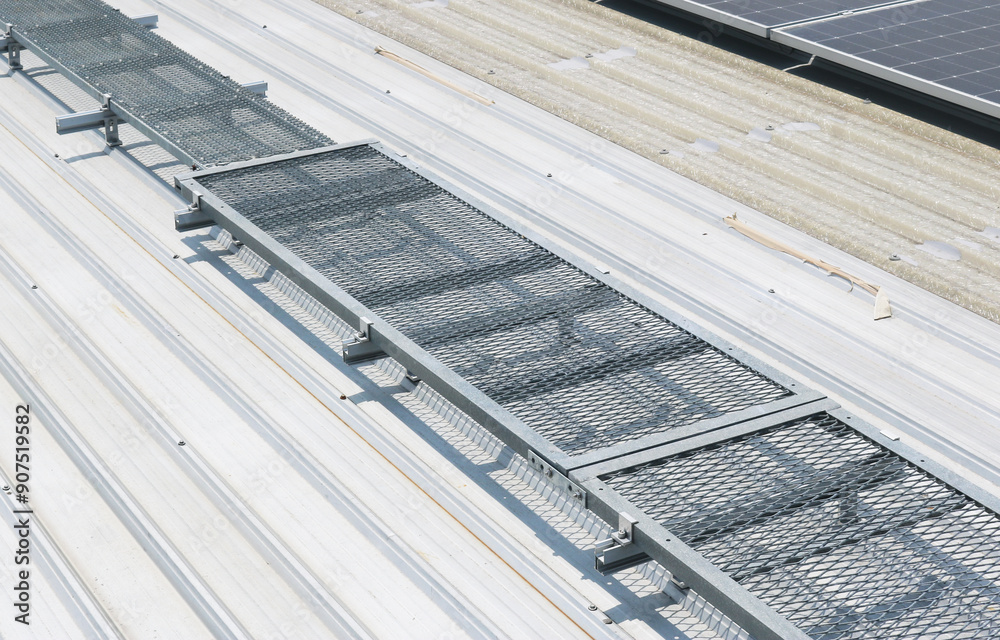 Fototapeta premium Steel catwalk grating structure installed on rooftop for maintenance.