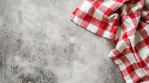 A rustic kitchen table with a red and white chequered tablecloth, napkins, and food-ready setup. Perfect for picnic and traditional dining themes.