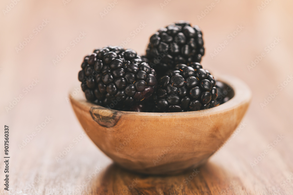 fresh blackberries in wood bowl on wooden table fresh blackberries in wood bowl on wooden table