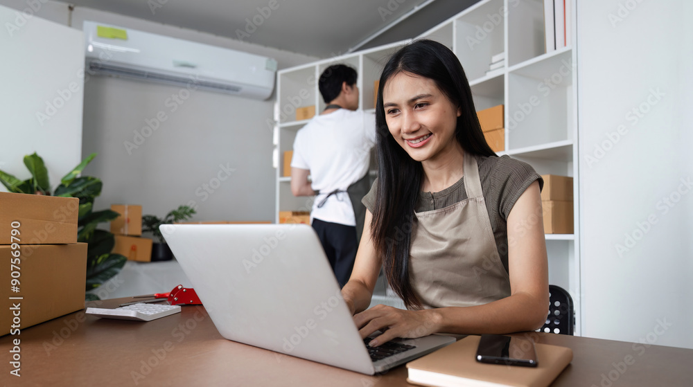 Couple Working Together in Home Office for Their Online Business with Laptops and Packaging Boxes