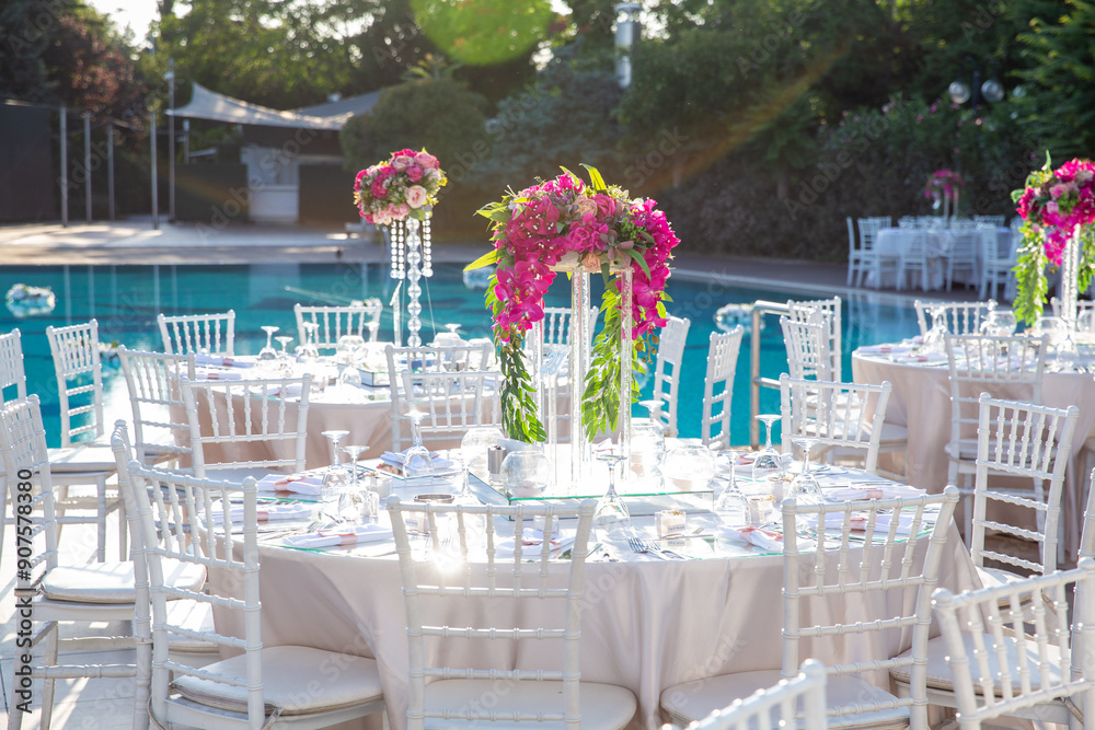 Beautifully Decorated Wedding Tables by the Swimming Pool Outdoors