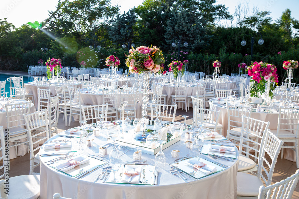 Beautifully Decorated Wedding Tables by the Swimming Pool Outdoors