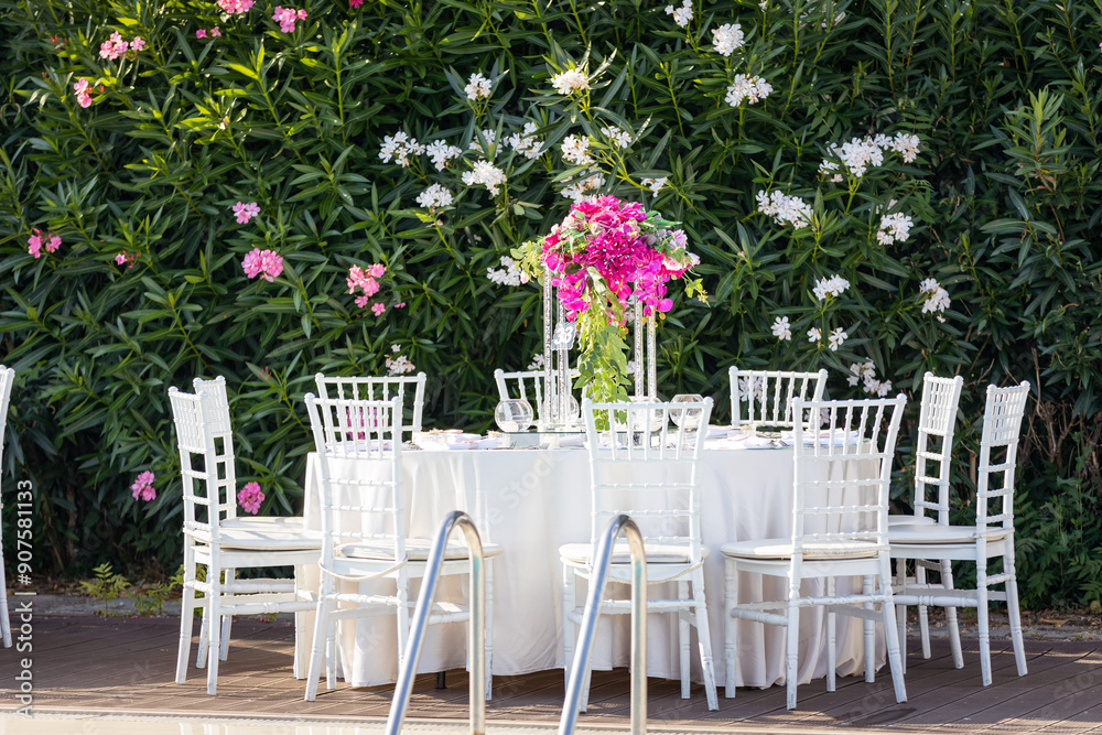 Beautifully Decorated Wedding Tables by the Swimming Pool Outdoors