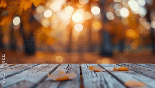 Autumn Leaves on Wooden Deck Surrounded by Blurry Orange Forest in Sunset Light