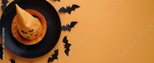 Creative Halloween Decor Featuring Black Bats and a Yellow Witch Hat on Orang...