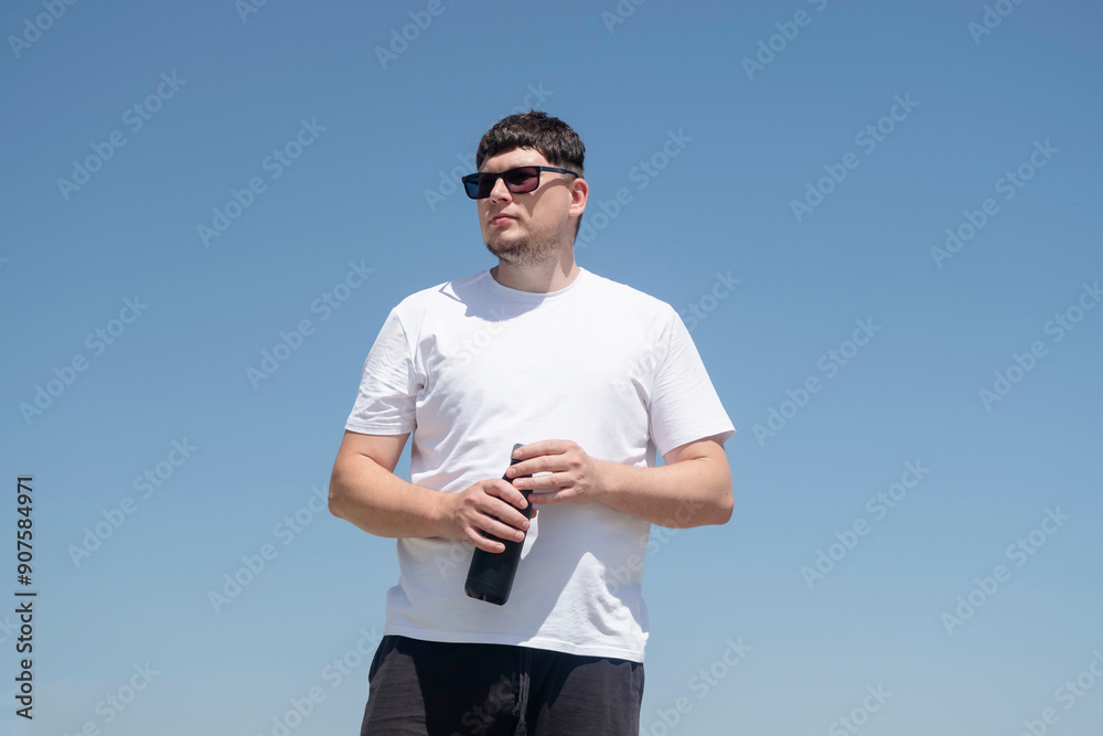 Fototapeta premium Sportive man workout drinking water from bottle