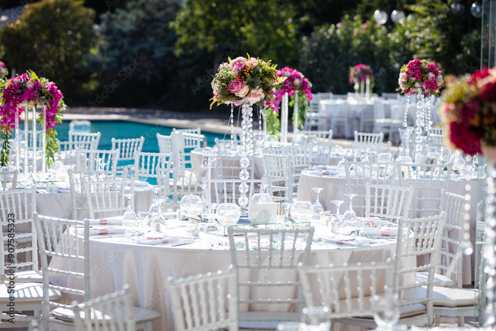 Beautifully Decorated Wedding Tables by the Swimming Pool Outdoors
