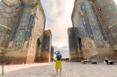 young Tourist looking the Gate of Ak Saray palace, built during time of Timur, Shakhrisabz, Uzbekistan. .Translation on mosque: 
