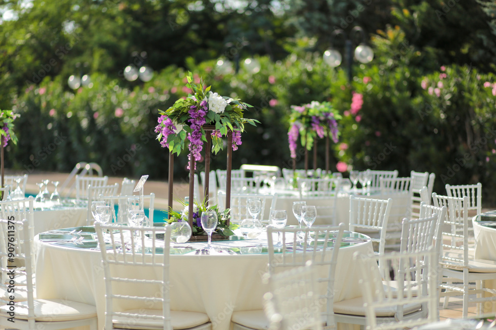 Beautifully Decorated Wedding Tables with Purple Flowers at Garden Event