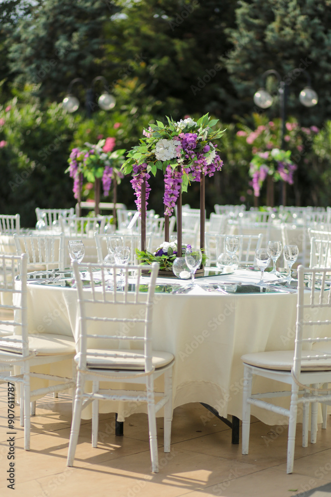 Beautifully Decorated Wedding Tables with Purple Flowers at Garden Event