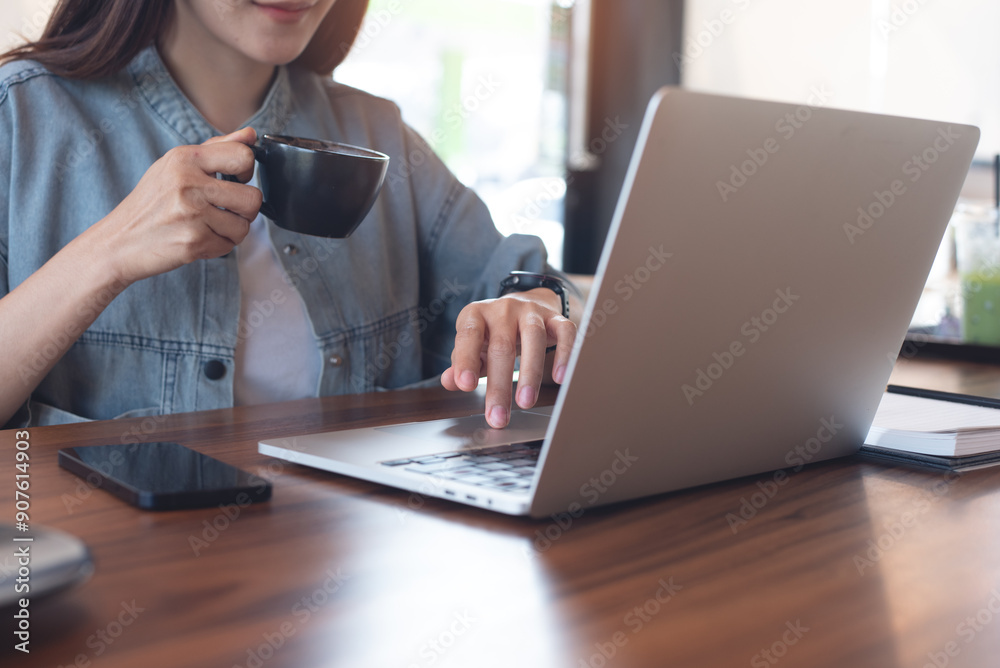 Woman online working on laptop computer at coffee shop, taking a coffee break, surfing the internet, business casual, freelance lifestyle, remote work, distance job Woman online working on laptop computer at coffee shop, taking a coffee break, surfing the internet, business casual, freelance lifestyle, remote work, distance job